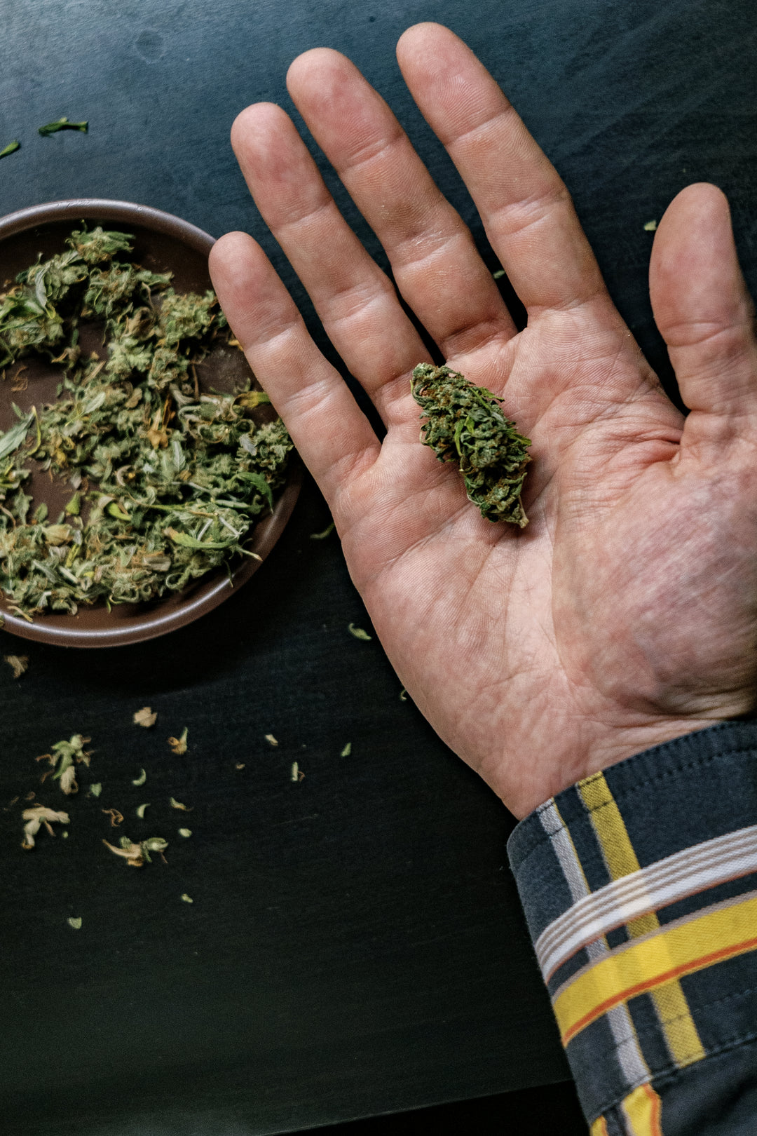 High angle view of hand holding food on table